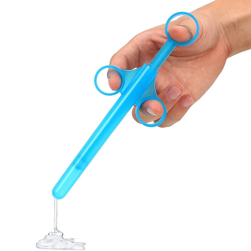 Blue lubricant applicator syringe dispensing gel smoothly from narrow tip, demonstrating precise and controlled lubricant application.